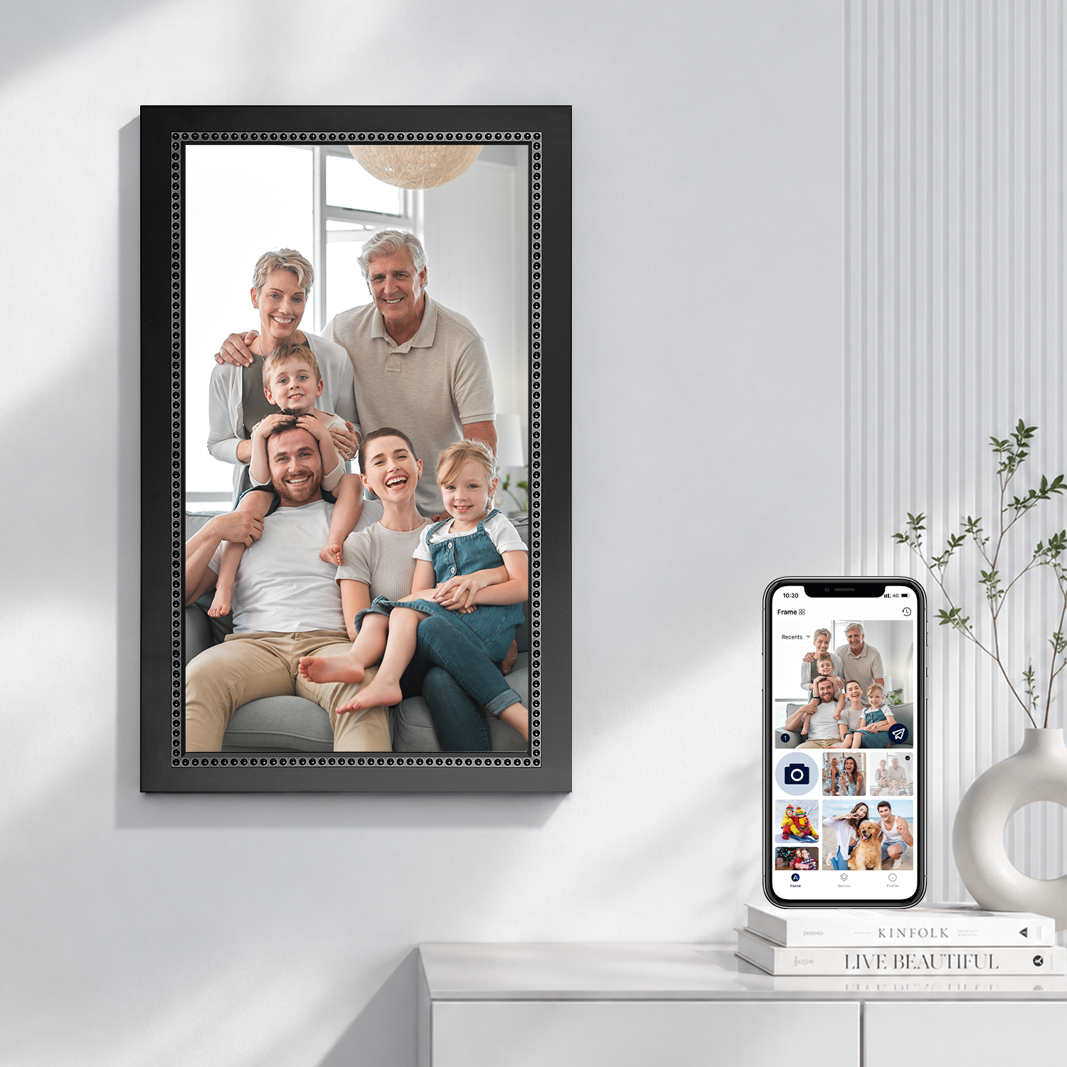 Wall-mounted digital picture frame with touch screen, black frame with family portrait and phone