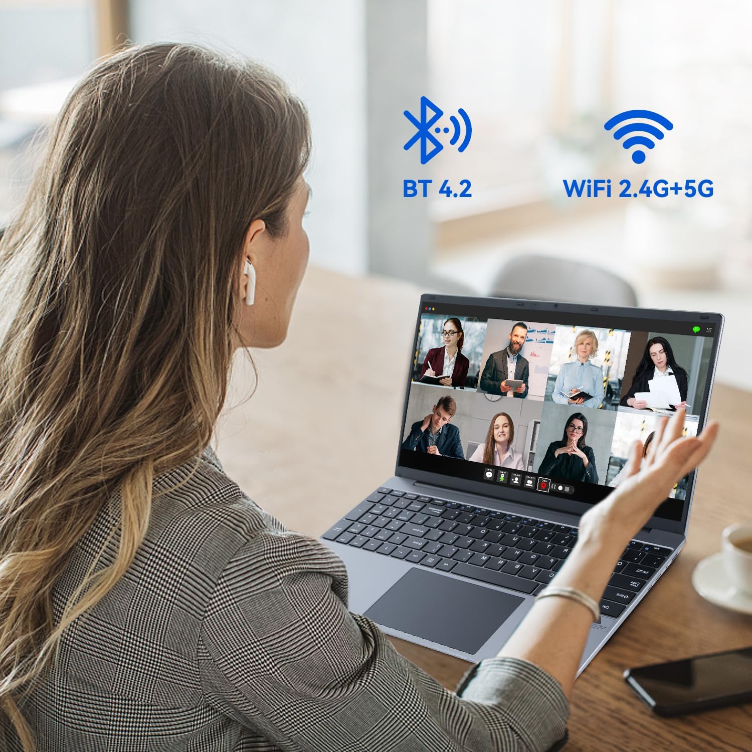 Silver laptop in use with video call grid on screen; WiFi and Bluetooth icons shown.